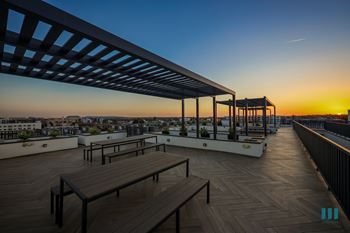 Rooftop deck with entertainment area and pergola